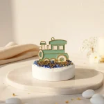 marturie de botez pentru baiat cu trenulet verde mentă si auriu pe piatra decorativa alba cu cristale albastre